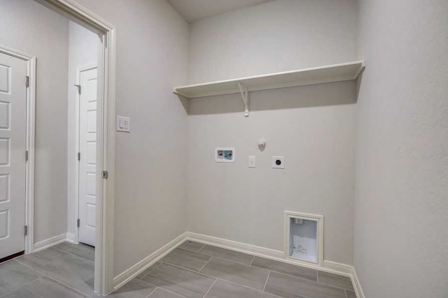 Laundry room in the Oleander floorplan at a Meritage Homes community.