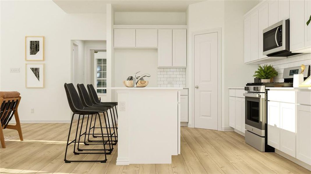 Kitchen featuring light wood-type flooring, backsplash, stainless steel appliances, and white cabinets