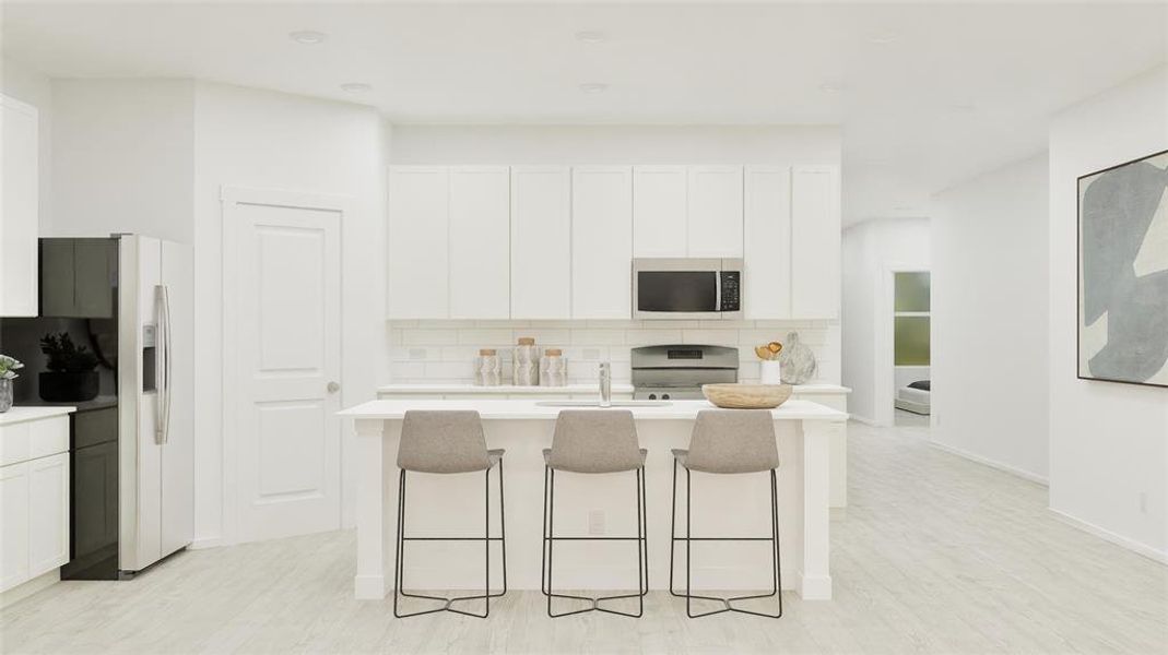 Kitchen featuring tasteful backsplash, a kitchen bar, white cabinetry, and stainless steel appliances Kitchen featuring tasteful backsplash, a kitchen bar, white cabinetry, and stainless steel appliances