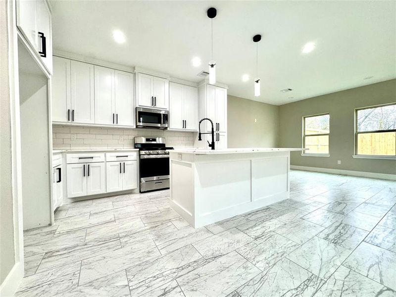 Large kitchen with custom, handmade cabinets.