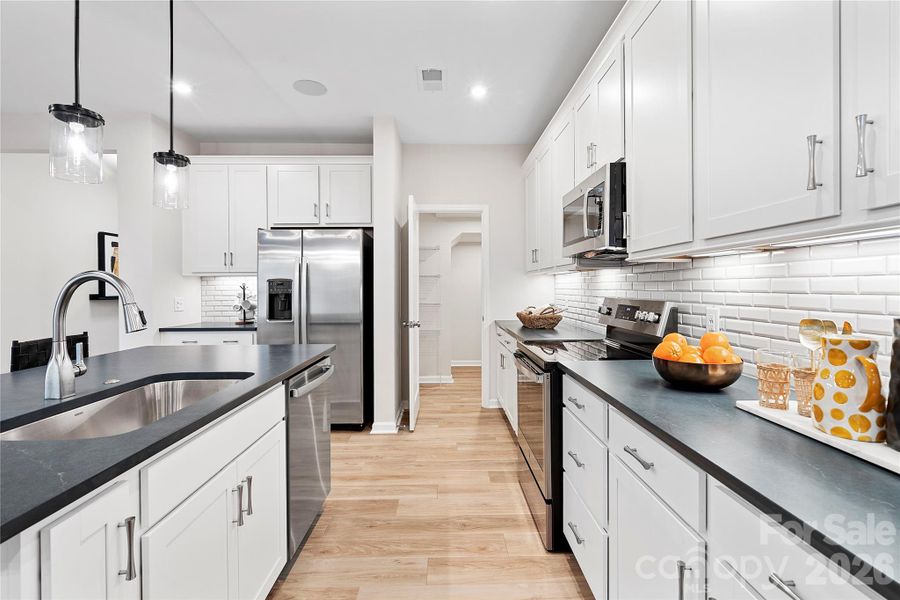 Quartz countertops and premium pendant lighting.