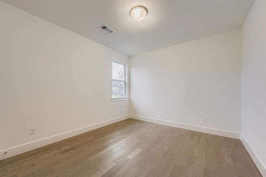Bedroom featuring light wood-style flooring Bedroom featuring light wood-style flooring
