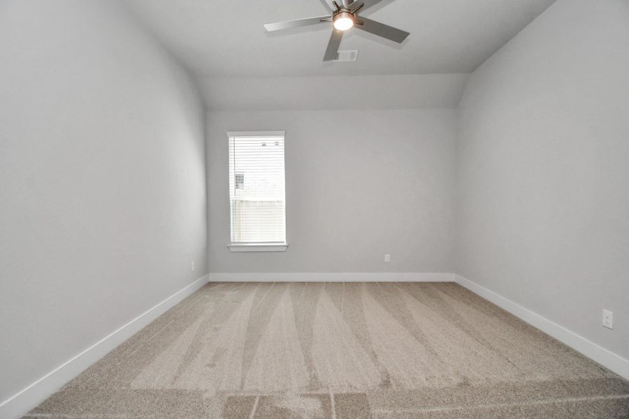 Secondary bedroom features plush carpeting, large windows that let in plenty of natural light, bright paint, and spacious closets. Sample photo of completed home with similar floor plan. Actual colors and selections may vary. Secondary bedroom features plush carpeting, large windows that let in plenty of natural light, bright paint, and spacious closets. Sample photo of completed home with similar floor plan. Actual colors and selections may vary.