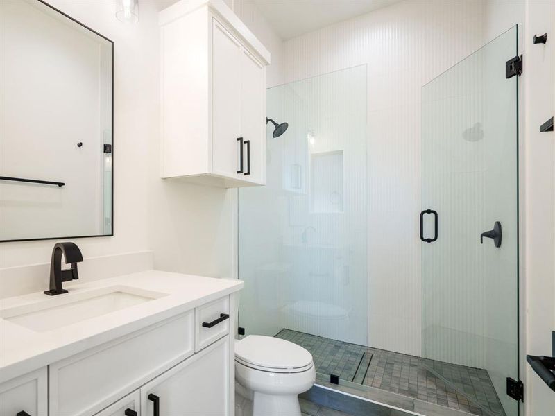 Full bath featuring vanity and a shower stall