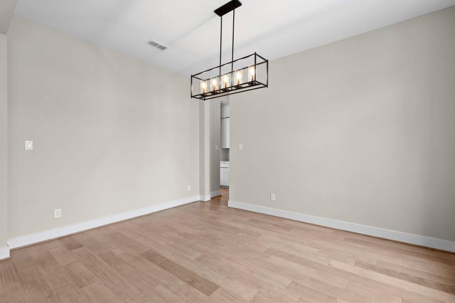 Bright and airy dining room overlooks the front courtyard