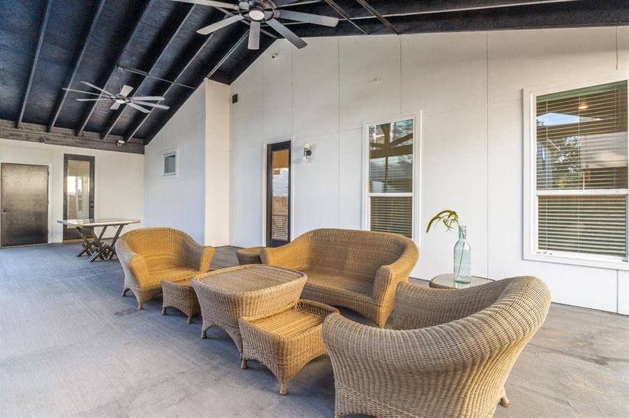 View of patio with an outdoor hangout area and ceiling fan