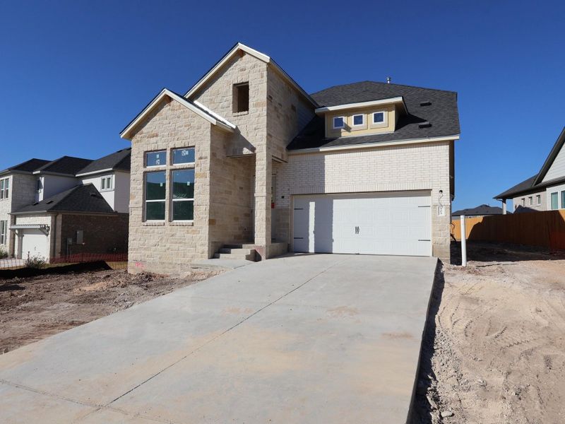 Front exterior of a new home in Cedar Brook, Leander, TX, highlighting curb appeal (Image 1). Front exterior of a new home in Cedar Brook, Leander, TX, highlighting curb appeal (Image 1).