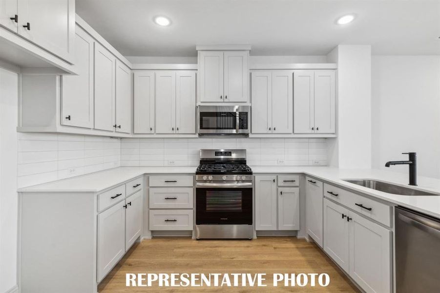 This thoughtfully designed kitchen offers plenty of storage and prep space!  REPRESENTATIVE PHOTO