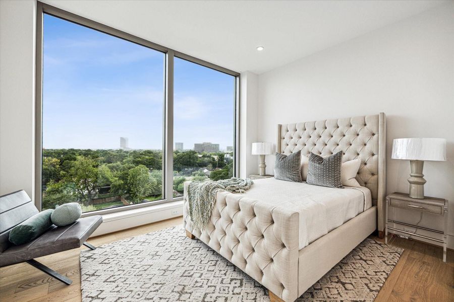 En-suite guest bedroom with floor-to-ceiling windows and stunning Southern views. Photos are of a similar unit with the same floor plan