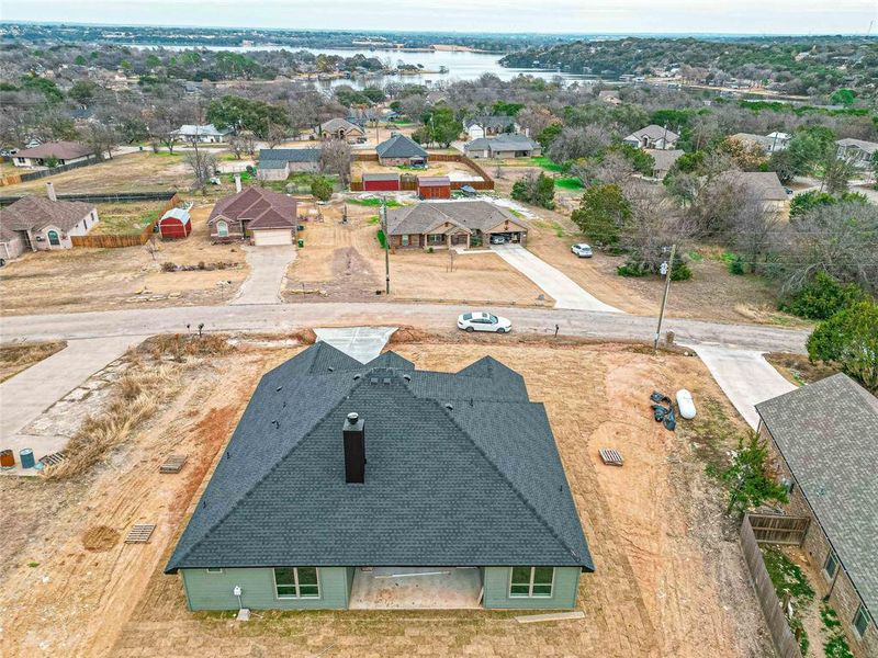 Birds eye view of property with a water view