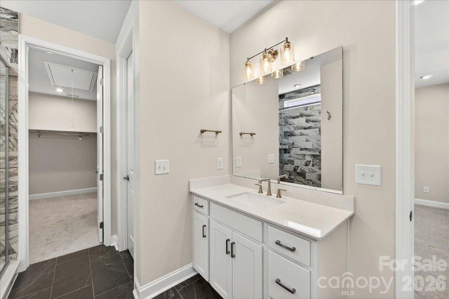 Primary bathroom with access to walk-in closet and laundry room Primary bathroom with access to walk-in closet and laundry room