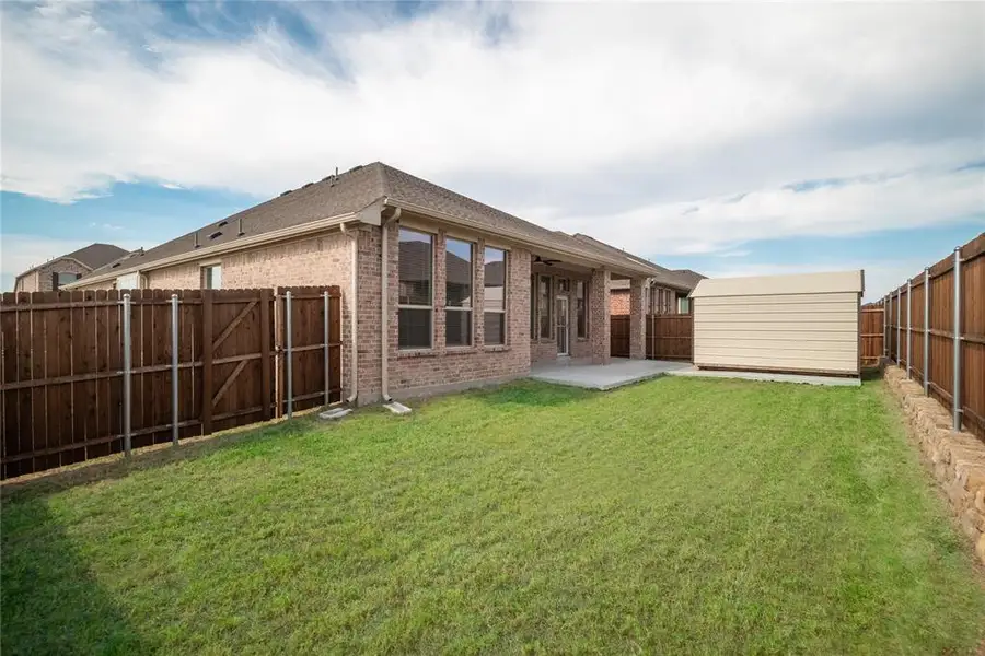 Back yard view with extended patio and oversized shed Back yard view with extended patio and oversized shed