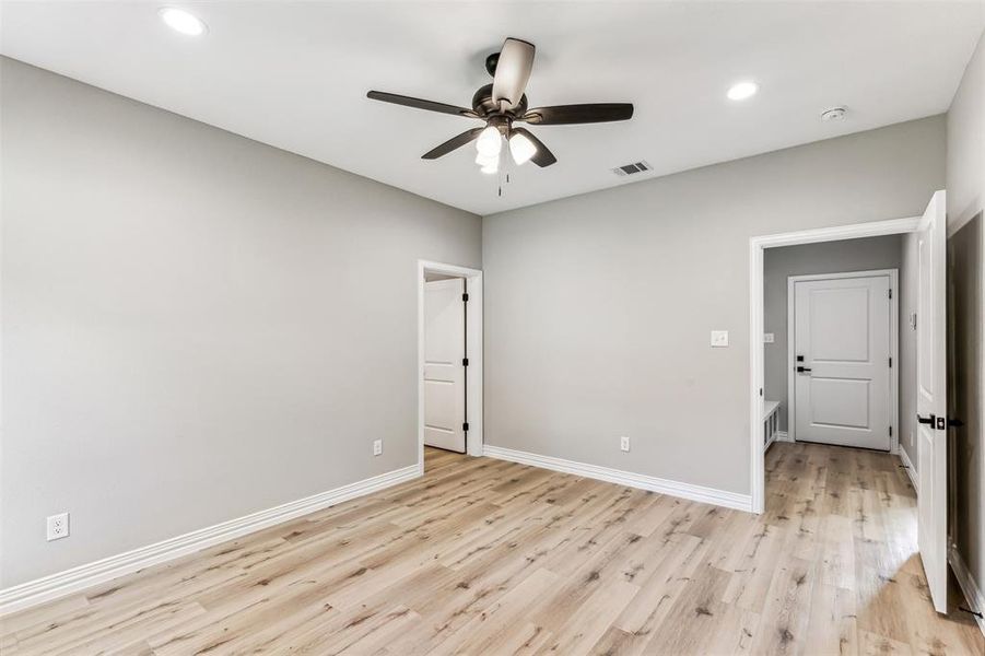 Unfurnished room featuring ceiling fan and light wood-type flooring