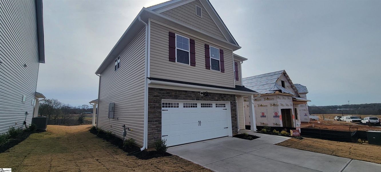 Front exterior of a new home in Halton Oaks, Spartanburg, SC, highlighting curb appeal (Image 2).