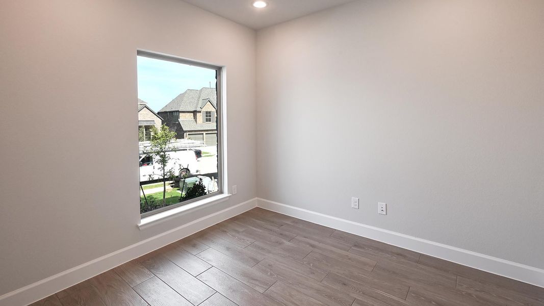 Empty room featuring wood finished floors and recessed lighting