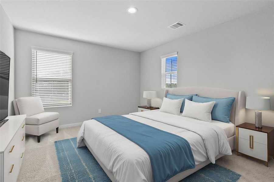 Secondary bedroom features plush carpet, custom paint, lighting, ample closet space, and large window with privacy blinds.