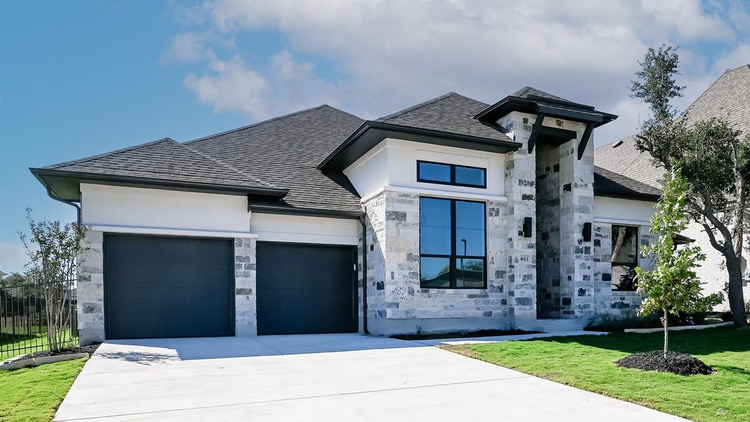 View of front of house featuring stone siding, driveway, roof with shingles, and an attached garage View of front of house featuring stone siding, driveway, roof with shingles, and an attached garage