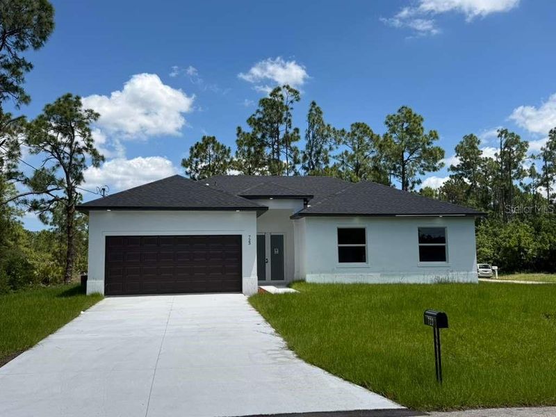 Front exterior of a new home in , Lehigh Acres, FL, highlighting curb appeal (Image 19). Front exterior of a new home in , Lehigh Acres, FL, highlighting curb appeal (Image 19).