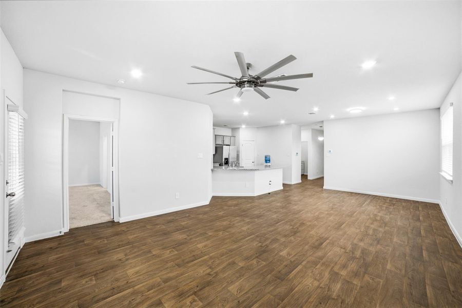 Unfurnished living room featuring recessed lighting, dark wood-style floors, and ceiling fan Unfurnished living room featuring recessed lighting, dark wood-style floors, and ceiling fan