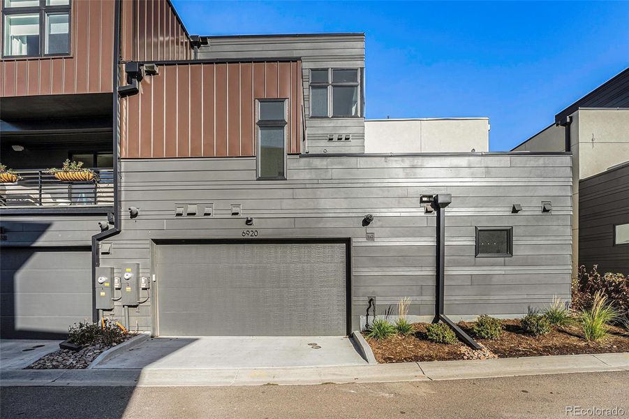 Attached 2 car garage with electric car charger and solar panel box