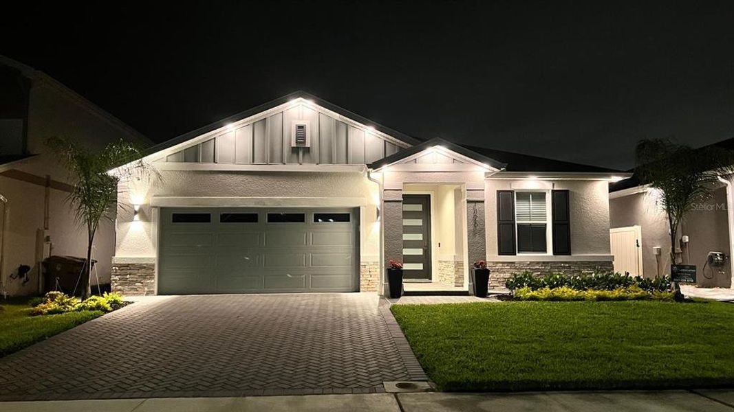 Front exterior of a new home in Seasons at Big Sky, Kissimmee, FL, highlighting curb appeal (Image 13).