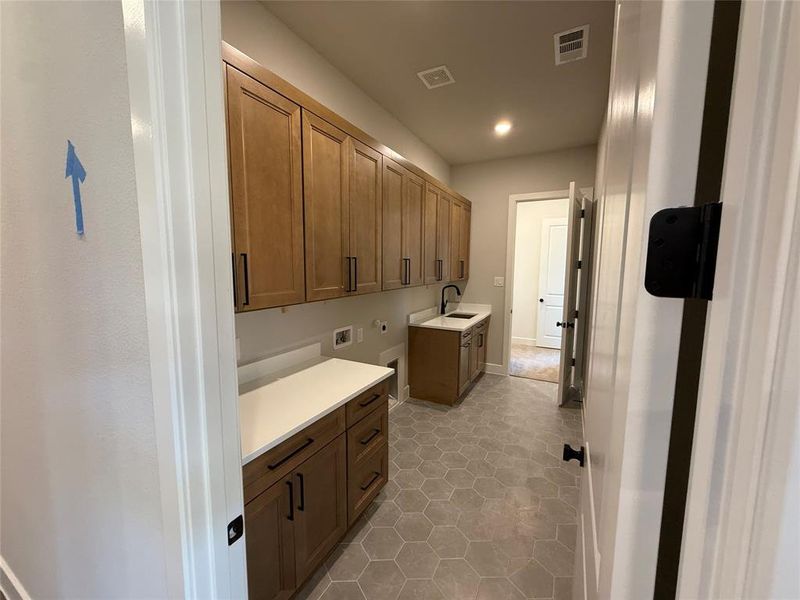 Laundry room featuring cabinet space, washer hookup, hookup for an electric dryer, light tile patterned floors, and recessed lighting