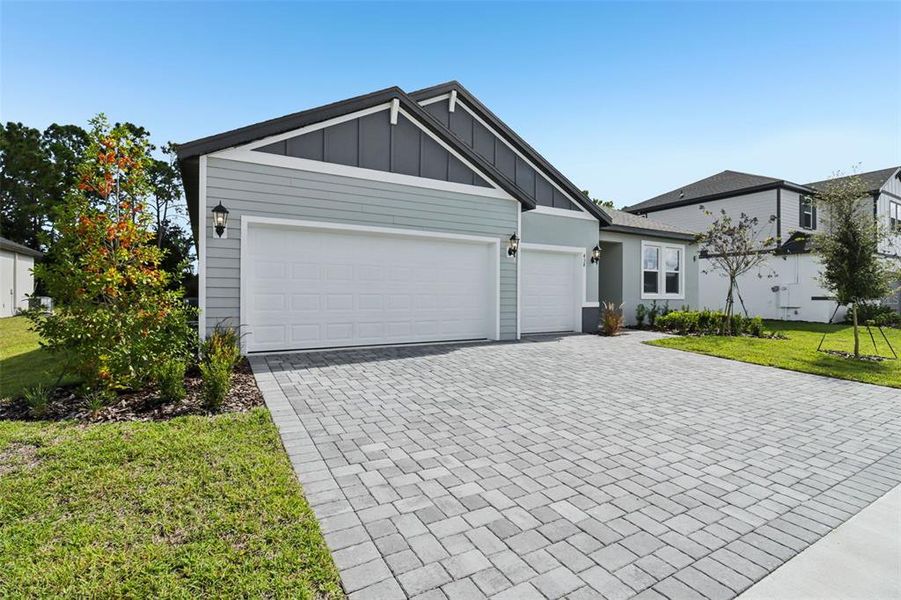 Front exterior of a new home in Ridgehaven - Reserve Series, Ormond Beach, FL, highlighting curb appeal (Image 21).