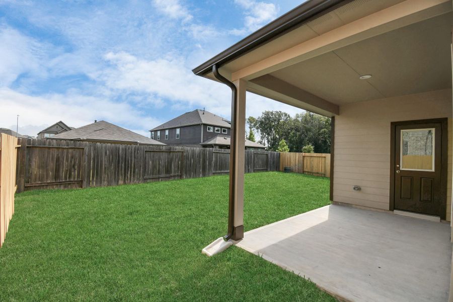 Experience outdoor living at its finest on this expansive covered patio, thoughtfully designed for BBQs and delightful outdoor dining.