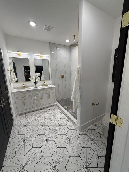 Master Bathroom featuring  double vanity, double shower heads including Rain shower, beautiful tile patterned floors, and tiled Rain shower