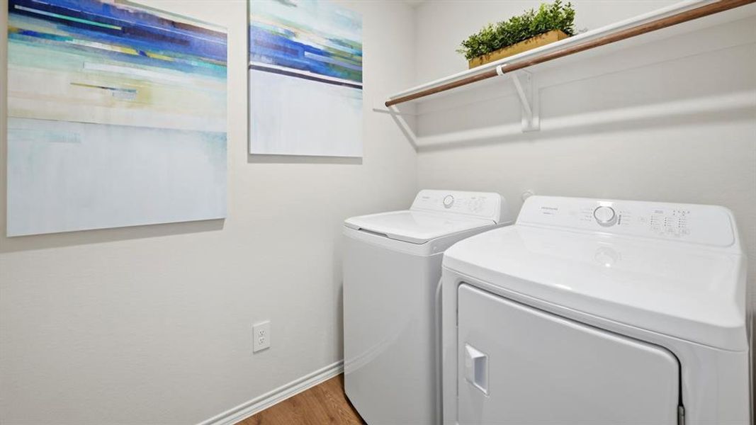 The laundry area features a washer and dryer, an overhead shelf, and hardwood flooring