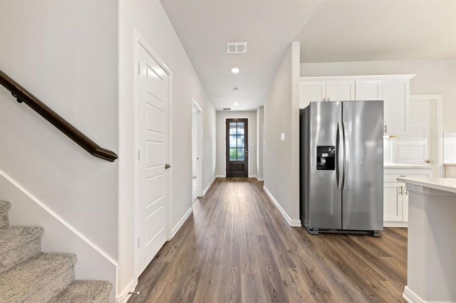 With a stunning wood and glass front door and ample wall space to display art work, you will love inviting friends and family into this beautiful home!