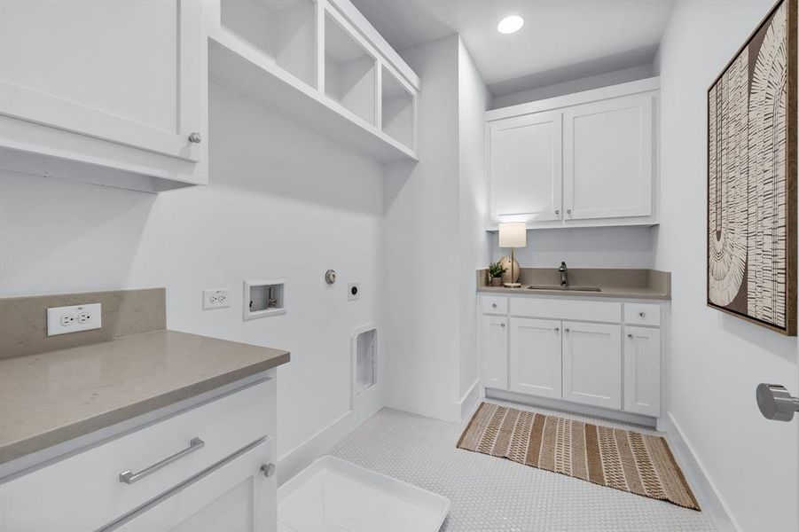 Laundry area featuring cabinets, hookup for a washing machine, electric dryer hookup, hookup for a gas dryer, and sink