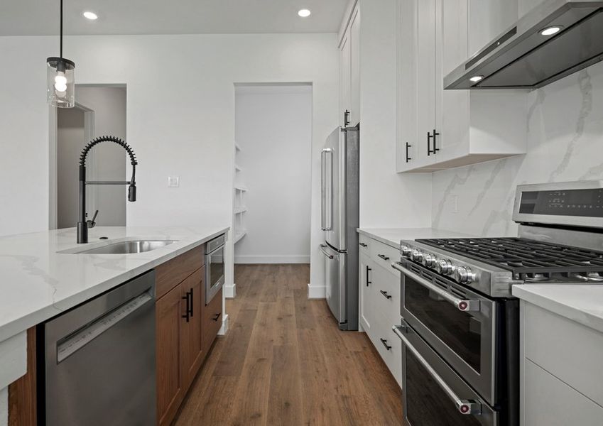 Stainless steel kitchen appliances are included.