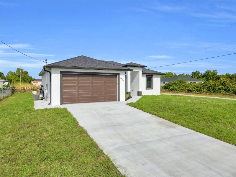Front exterior of a new home in , Lehigh Acres, FL, highlighting curb appeal (Image 25). Front exterior of a new home in , Lehigh Acres, FL, highlighting curb appeal (Image 25).