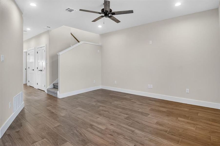living room, stairs, and entry hall view from the backdoor
