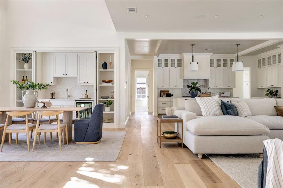 Living room featuring light hardwood / wood-style flooring, wine cooler, and sink