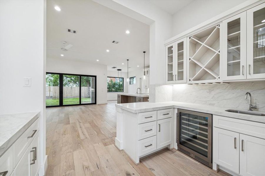 Wet bar / butler's pantry between family room / kitchen and dining room includes wine / beverage refrigerator and ice maker.