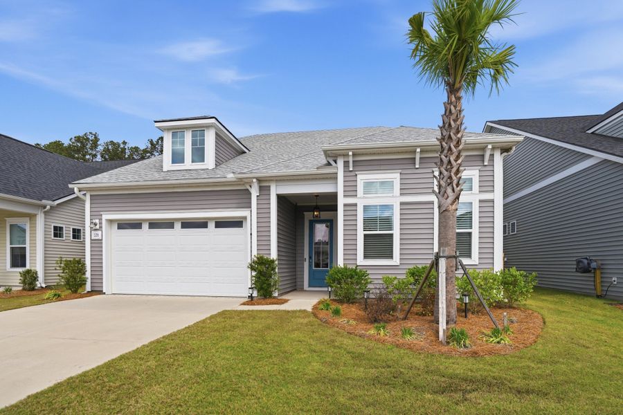 Front exterior of a new home in Summerwind Crossing at Lakes of Cane Bay, Summerville, SC, highlighting curb appeal (Image 23).