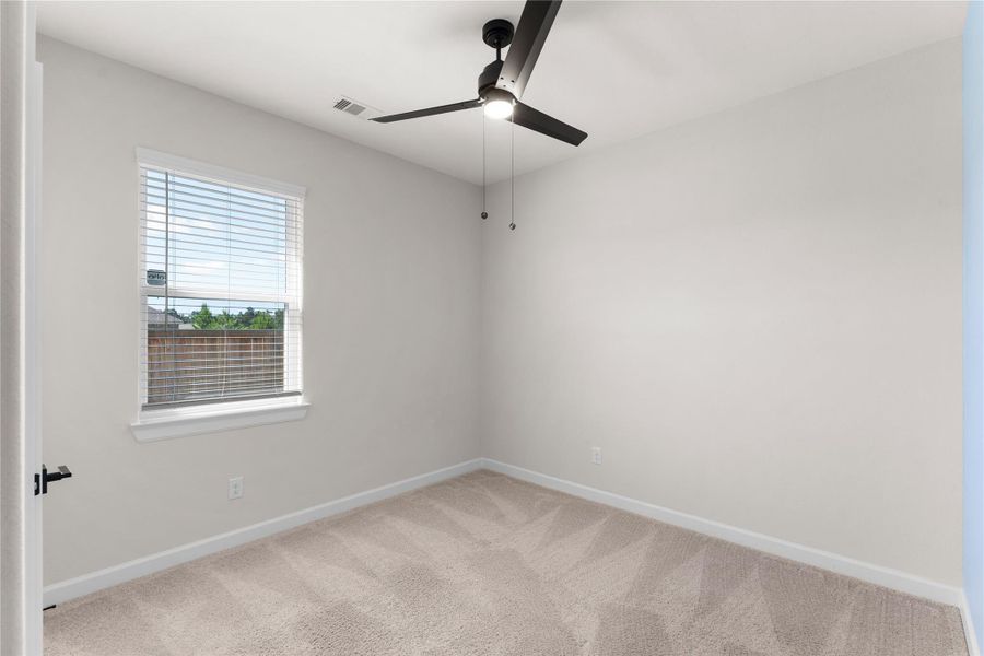 Additional secondary bedroom with soft carpeting, ceiling fan, and neutral finishes, offering a comfortable space for family, guests, or a home office Additional secondary bedroom with soft carpeting, ceiling fan, and neutral finishes, offering a comfortable space for family, guests, or a home office