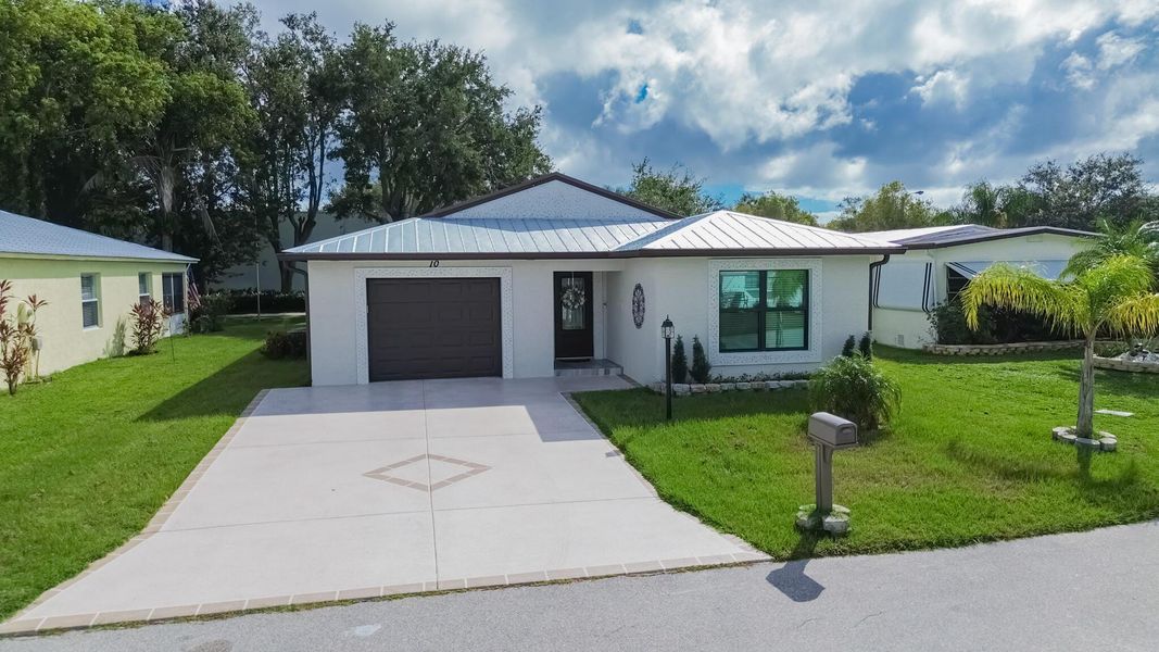 Front exterior of a new home in , Port St. Lucie, FL, highlighting curb appeal (Image 2).