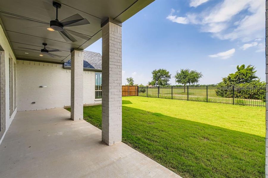 Fenced backyard featuring a patio area and a ceiling fan Fenced backyard featuring a patio area and a ceiling fan