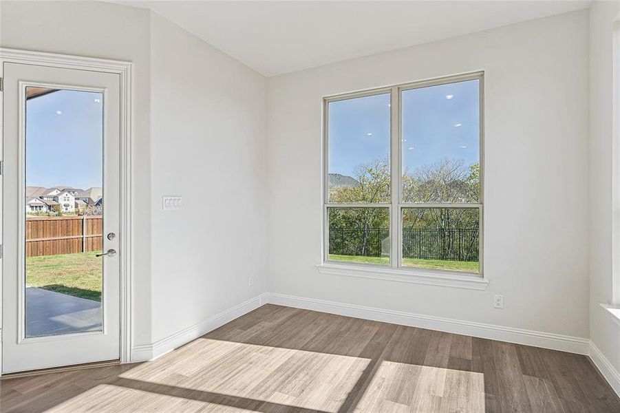 Empty room with light hardwood / wood-style flooring and plenty of natural light