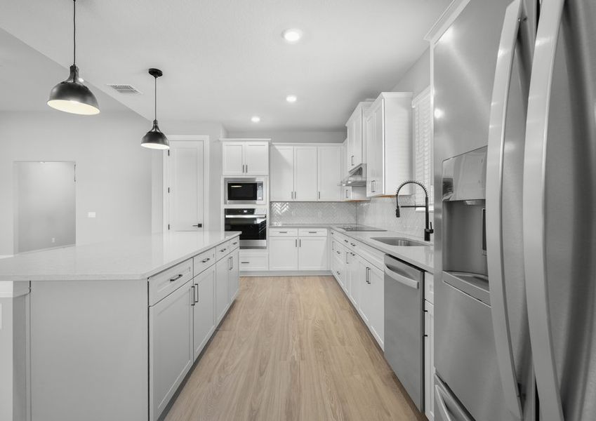 Stainless steel kitchen appliances are included.