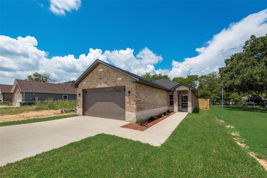 View of front of home with a garage and a front yard