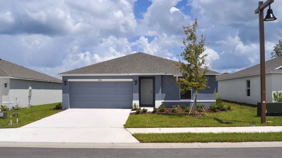 Front exterior of a new home in Oakfield Lakes, Parrish, FL, highlighting curb appeal (Image 1). Front exterior of a new home in Oakfield Lakes, Parrish, FL, highlighting curb appeal (Image 1).