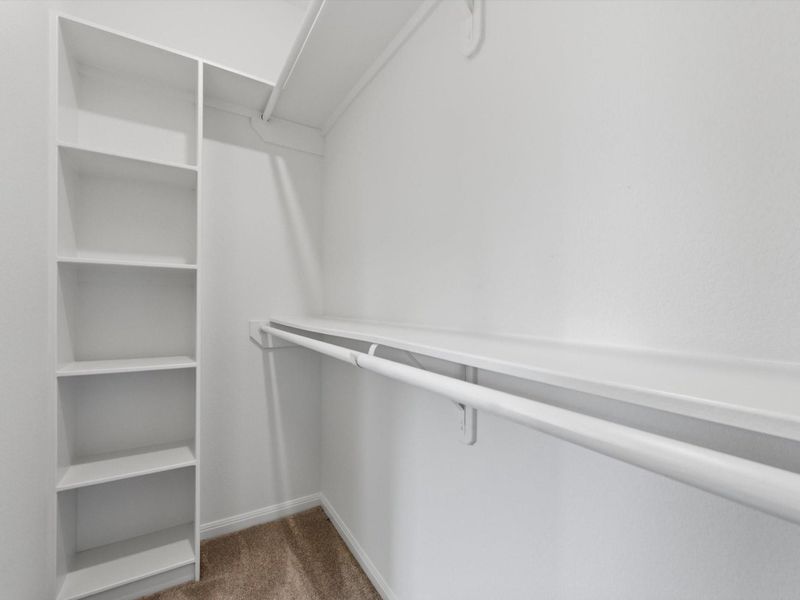 Designed for both function and ease, the spacious primary closet features built-in storage and abundant room for effortless organization.