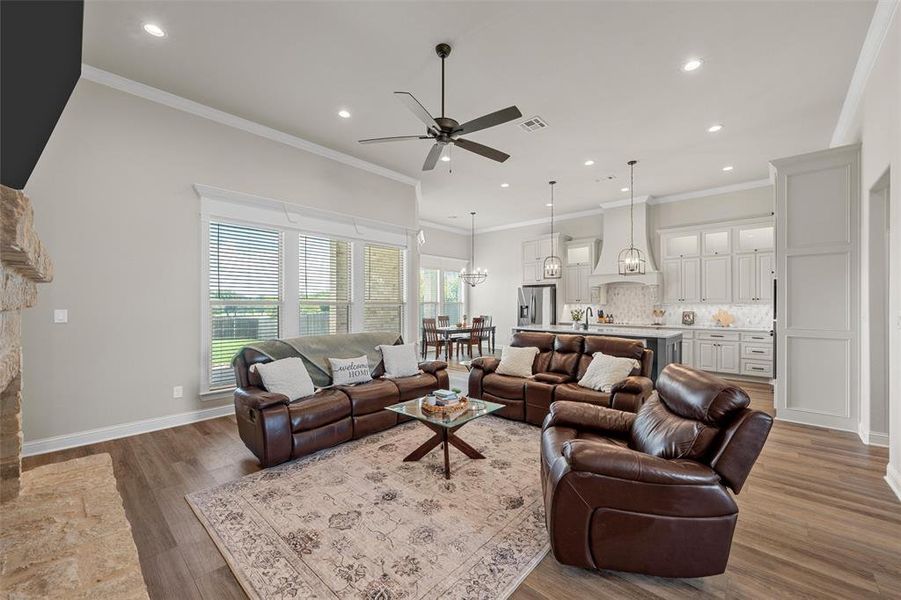 Open living area with 12-foot ceilings, luxury vinyl plank flooring, and abundant natural light. Open living area with 12-foot ceilings, luxury vinyl plank flooring, and abundant natural light.