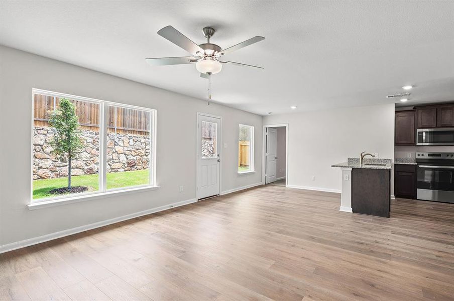 Unfurnished living room with ceiling fan, light wood-type flooring, and recessed lighting