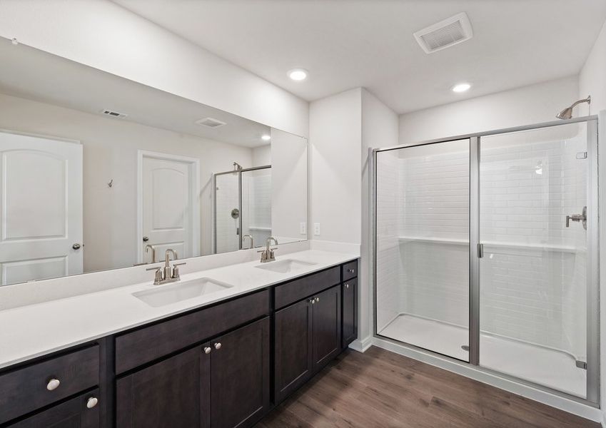 The master bathroom has a sprawling dual-sink vanity and walk-in, glass shower. The master bathroom has a sprawling dual-sink vanity and walk-in, glass shower.