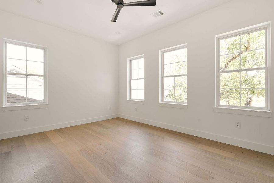 Spare room with light wood finished floors, ceiling fan, and recessed lighting Spare room with light wood finished floors, ceiling fan, and recessed lighting